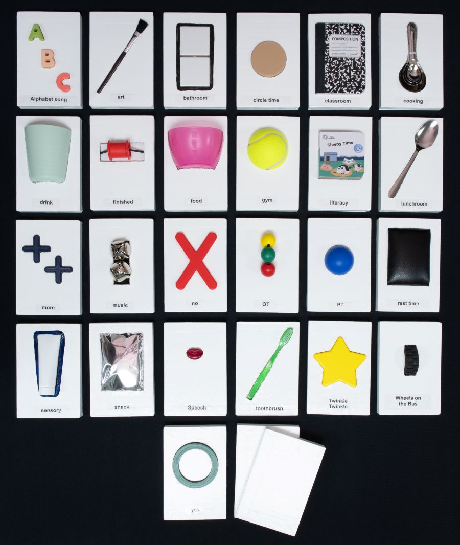 Set of handmade communication cards laid out in a grid. Each card has varied textures and features a white background for high-contrast and enhanced visibility. Cards provide a 3D copy of everyday items, including paintbrush, notebook, spoon, cup, ball, toothbrush, star.