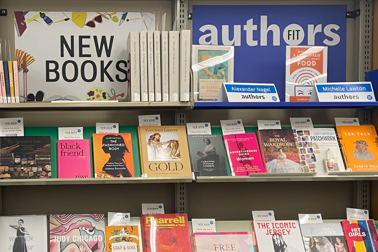 A close-up view of several colorful academic books lined up on a library shelf.