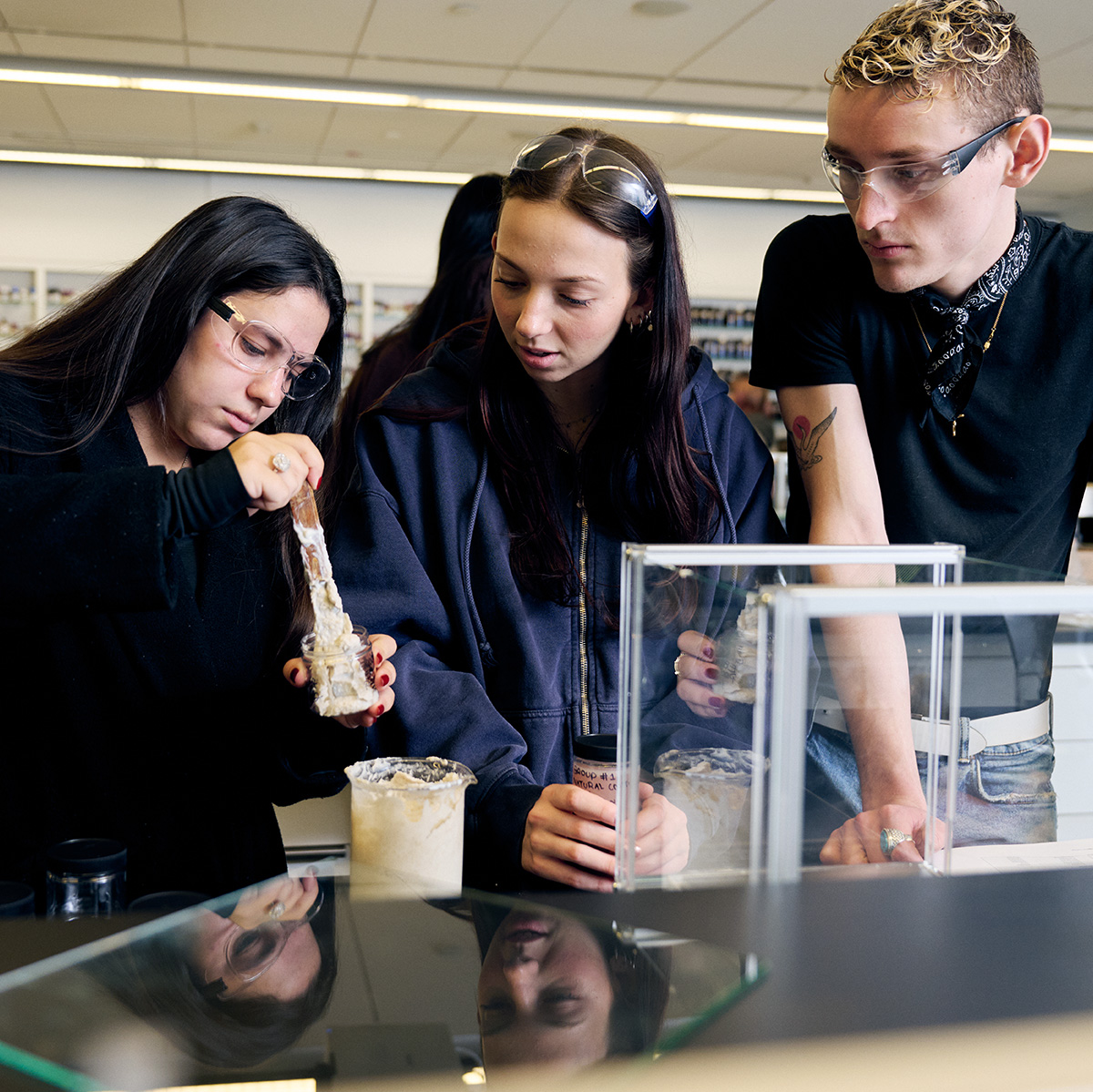 Students mixing substances for perfume making