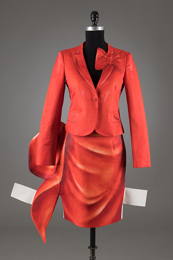 red jacket and skirt withprint of trompe l'oeil draping and protruding white tabs like paper dolls