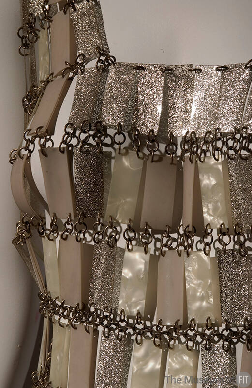 dress composed of shimmering beige, cream, and gold rectangular pieces chained together